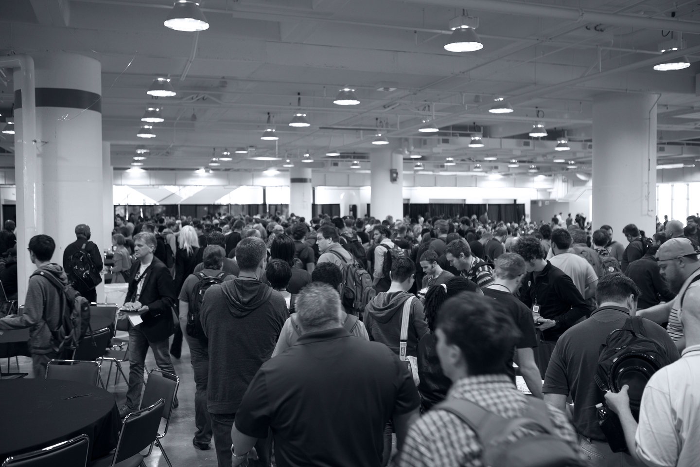 Crowded lobby with conference participants entering workshop rooms