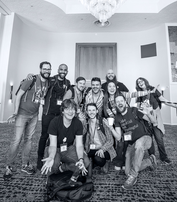 Group of developers hugging and smiling together